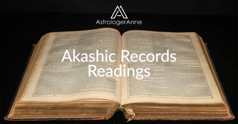 Ancient book open on dark table against dark background for Akashic Records Readings by Astrologer Anne